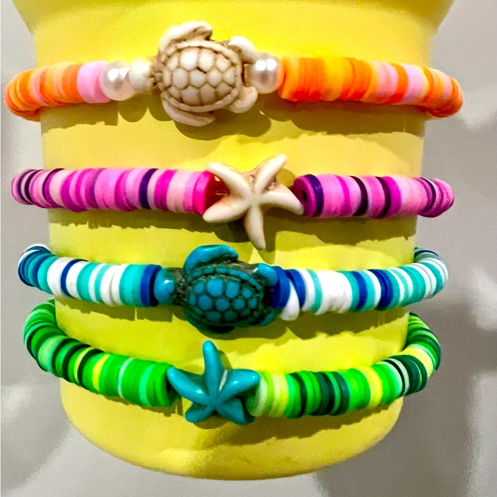 Coastal theme beaded bracelet stack. Turtle and Starfish charm set.